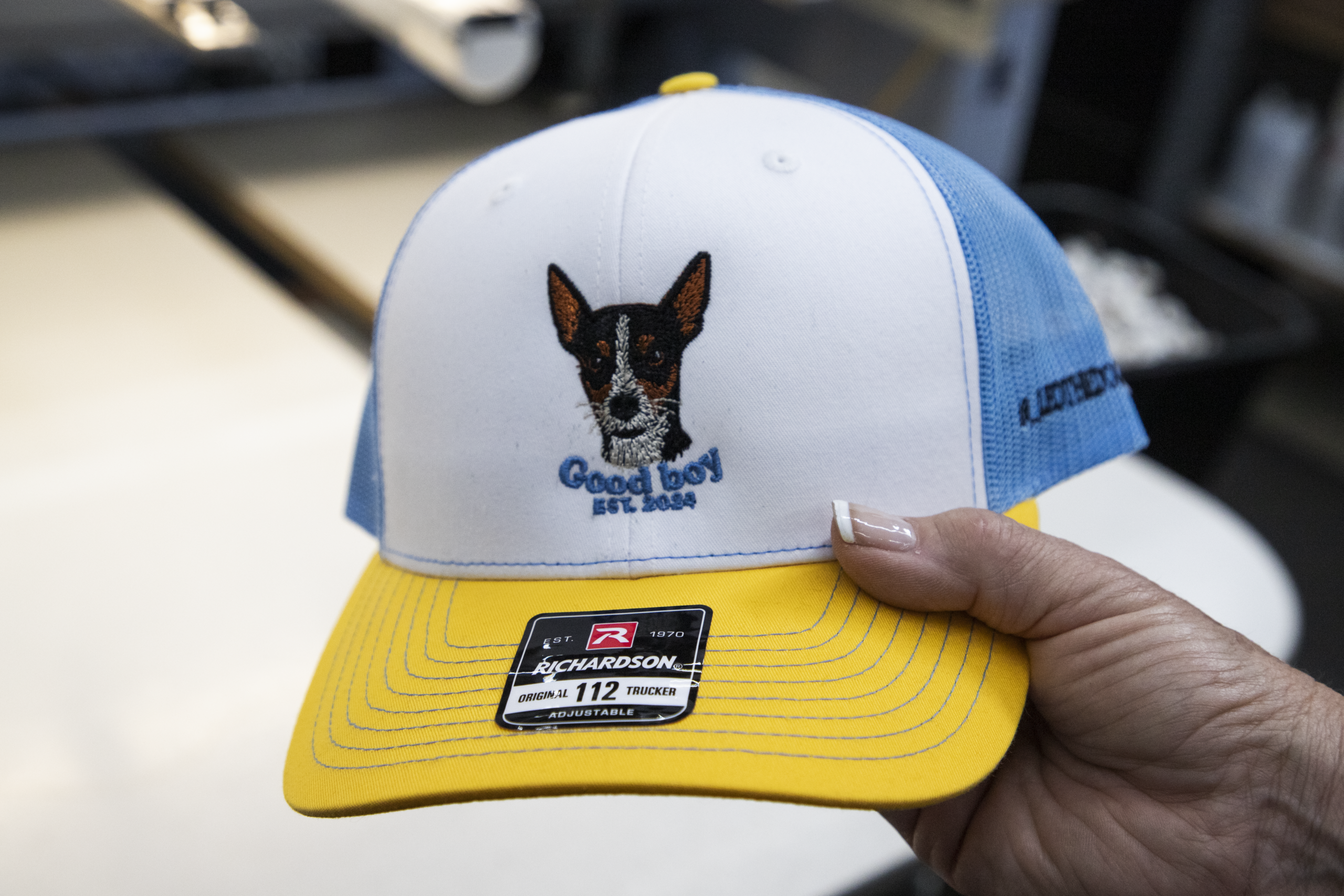 Custom embroidered trucker hat with detailed dog logo on Richardson 112 cap