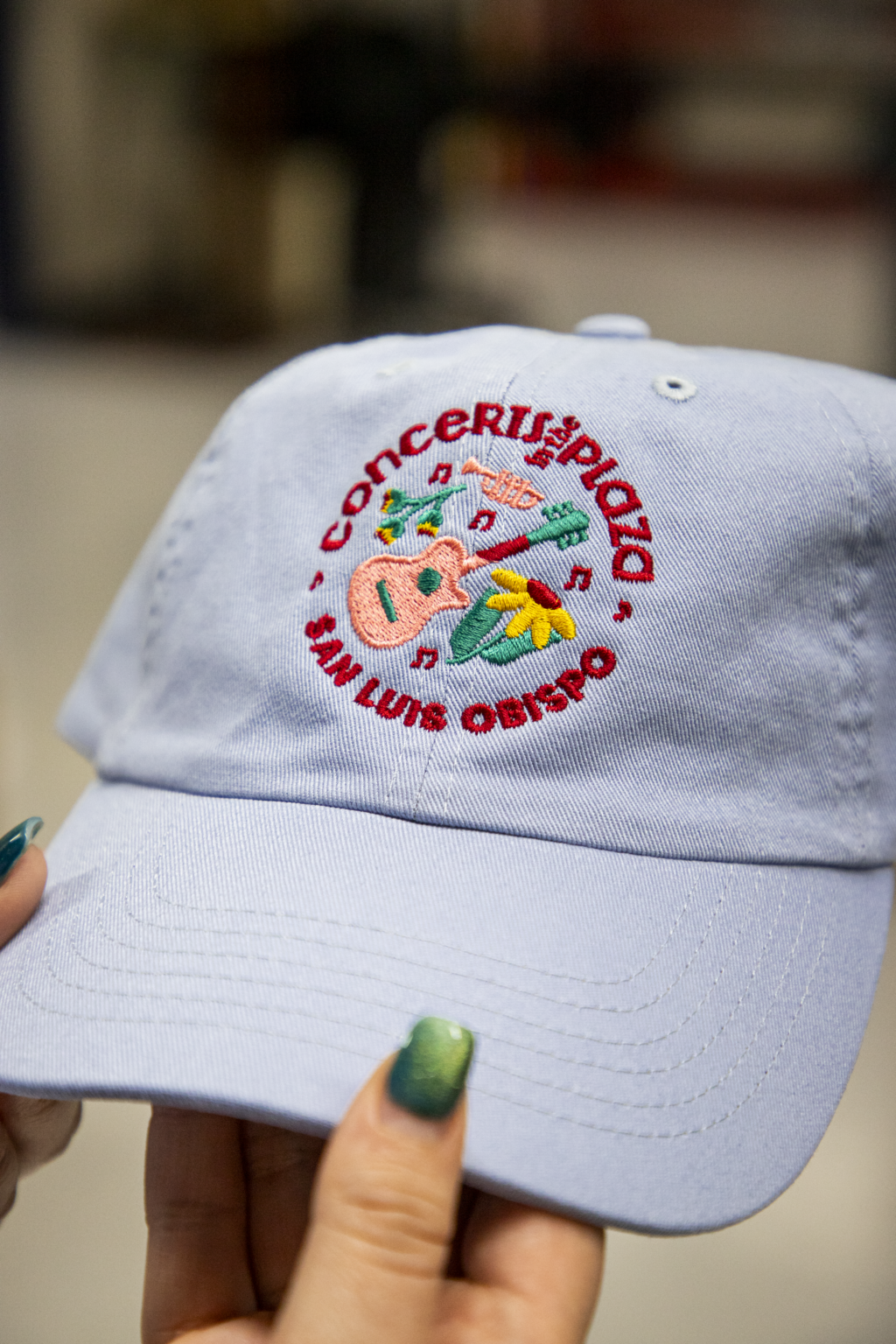 Custom embroidered logo for Concerts in the Plaza San Luis Obispo on light blue unstructured cap