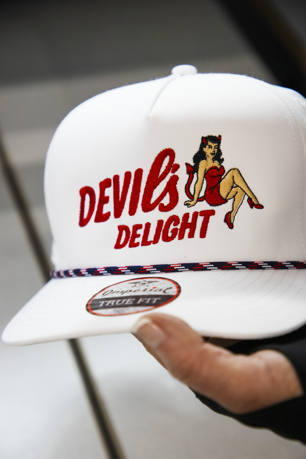 Custom embroidered design for Devil's Design on white trucker cap