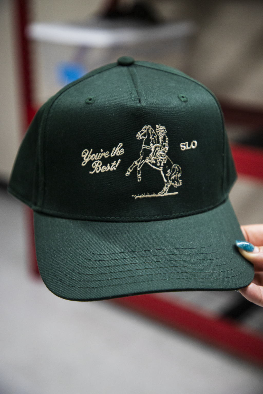 Custom embroidered "You're The Best" design on green trucker cap